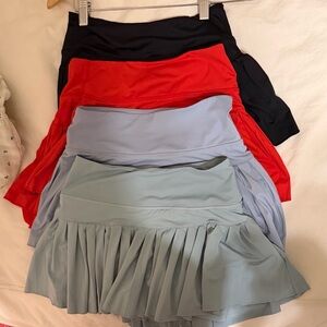 Goldhinge pleated skirt 4 pack! Size S. Red, black, light green, light blue.